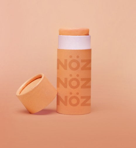 Orange Noz stick sunscreen opened ready to use